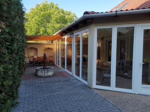 a conservatory with sliding glass doors and a patio at Harmónia Panzió in Sárospatak