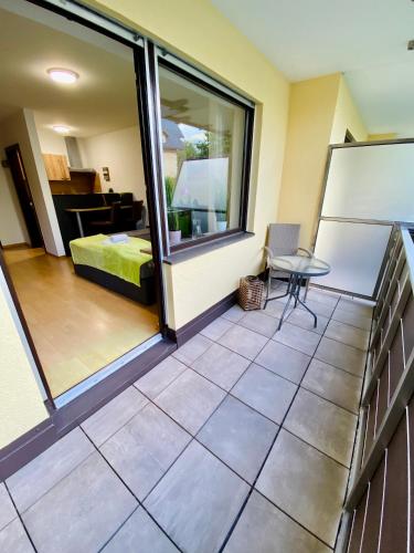 a room with a balcony with a table and a bed at Apartment Dachstein nahe Zentrum in Bad Ischl