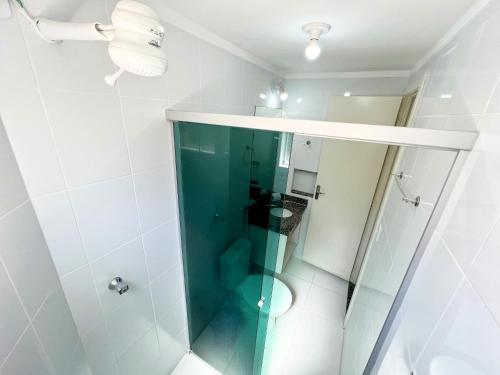 a bathroom with a glass shower with a toilet at L'acqua diroma I, II, III, IV e V- Aptos in Caldas Novas