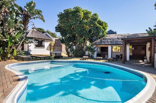 a swimming pool in front of a house at Unit 2a @ The Thatches in Kei-mouth Village