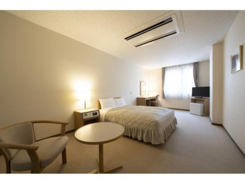 a hotel room with a bed and a table and a chair at Seto Park Hotel - Vacation STAY 83745v in Seto