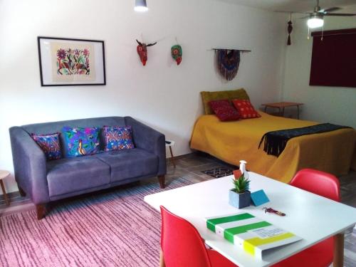 a living room with a couch and a bed at HospedArte Loreto in Loreto
