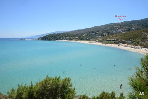 a view of a beach with people in the water at Ikaros Star Hotel in Gialiskari