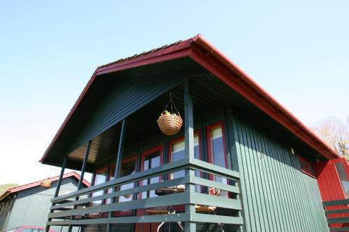 a building with a basket on the side of it at Logierait Pine Lodges in Pitlochry