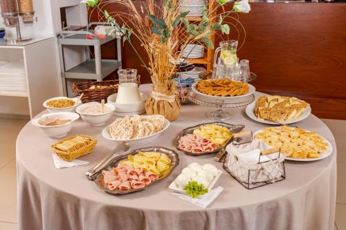 a table with many plates of food on it at Hotel Bahamas in Montevideo