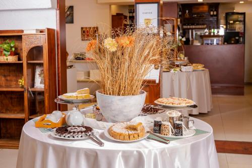 a table with cakes and desserts on plates on it at Hotel Bahamas in Montevideo