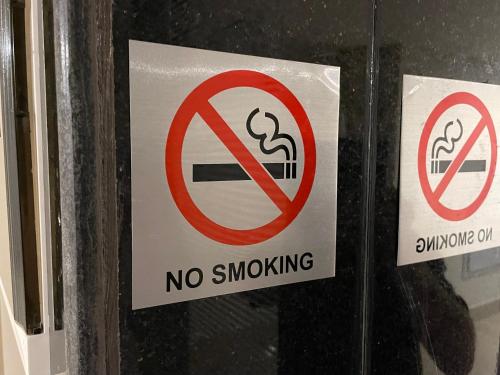 a no smoking sign on a glass door at Mizirawi Historic Hotel in Ramallah