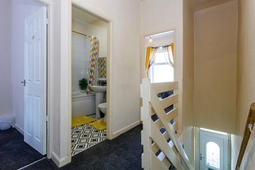 a small room with a staircase and a bathroom at 4 Beds Sleeps 6 - Elegance Leisure Stay, Burnley in Burnley