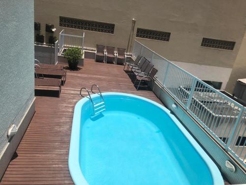 a swimming pool on a balcony of a building at Hotel Italia in Balneário Camboriú