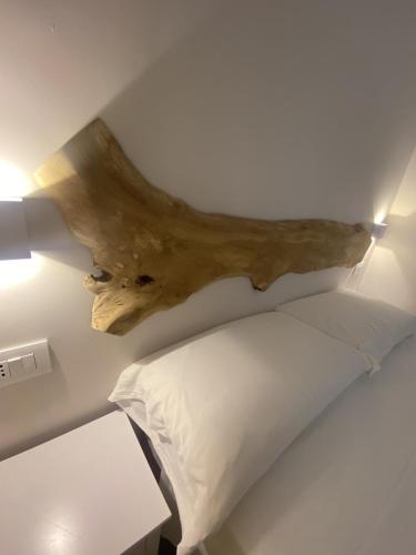 a bedroom with a bed and a wooden head board at Koralline accommodation in Tropea