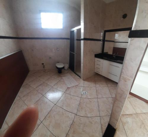 a bathroom with a sink and a toilet in it at suítes economy uberlandia in Uberlândia