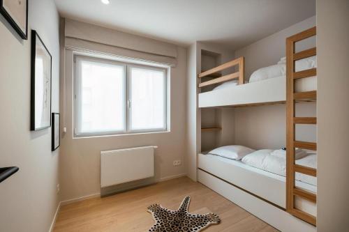 a small bedroom with bunk beds and a starfish on the floor at - Carijoca - Gemoderniseerd, lichtrijk & zijdelings zeezicht app in Koksijde