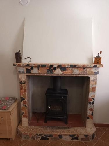 a brick fireplace with a stove in a room at CASOLARE TROMBACCO in Vergemoli