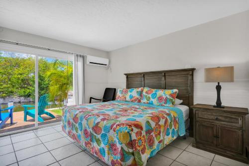 a bedroom with a bed and a sliding glass door at Coconut Cay Resort in Marathon