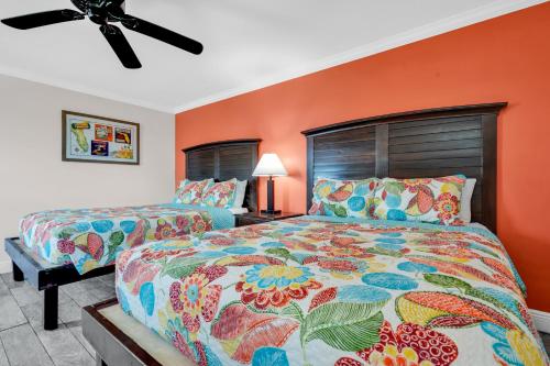 a bedroom with two beds and a ceiling fan at Coconut Cay Resort in Marathon