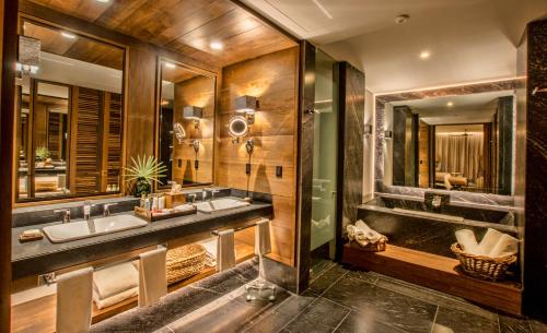 a bathroom with two sinks and a large mirror at Secrets Moxché Playa del Carmen - Adults Only - All Inclusive in Playa del Carmen