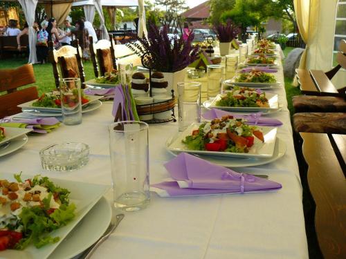 a long table with plates of food on it at Guest House Dan Kolov in Syennik