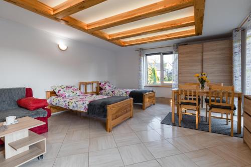 a living room with a couch and a table at Domek Rodzinny na Roztoczu in Nowiny