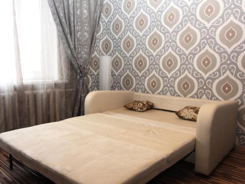 a bed with two pillows on it in a bedroom at ApartLux Tretyakovskaya in Moscow