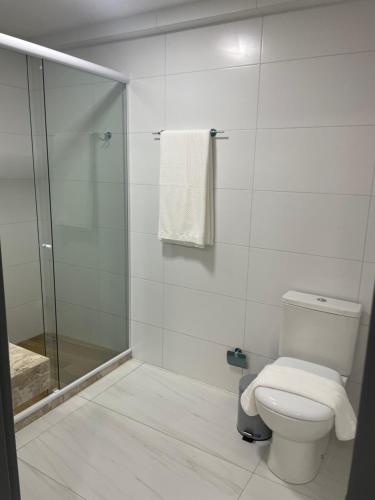 a bathroom with a toilet and a glass shower at Mardisa Design by Jess Hospedagens in João Pessoa