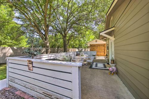 a backyard with a white fence next to a house at Cozy Canton Residence with Great Outdoor Space! in Canton