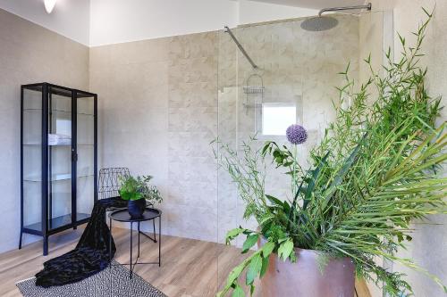 a room with plants and a chair and a mirror at Vila Vanesa with private pool near Rovinj - open 2022 in Rovinjsko Selo