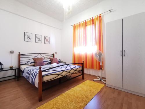 a bedroom with a bed and a window at Priska Apartment in Kaštela