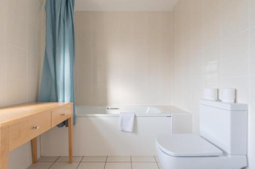 a bathroom with a white toilet and a sink at Brooklands Lodge in Bournemouth