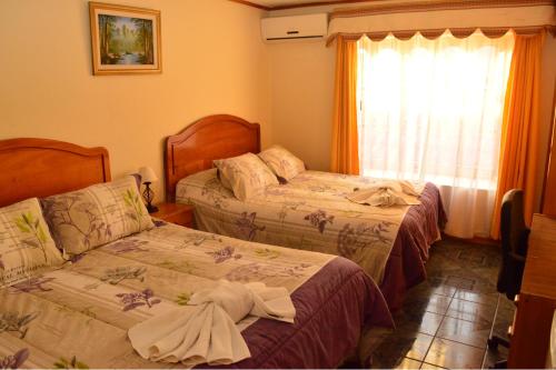 Un pat sau paturi într-o cameră la Hotel My House