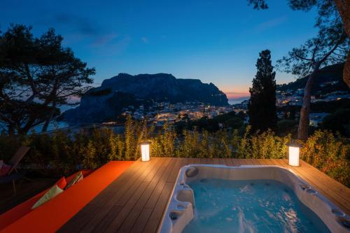a jacuzzi tub on a deck with a view at Villa Arabella in Capri