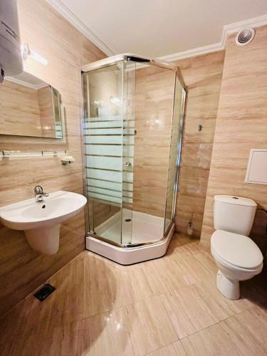 a bathroom with a shower and a toilet and a sink at Lovely studio directly to beach area in Lozenets