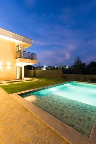 a swimming pool in front of a house at night at LUXURIOUS NEW HOUSE, UNFORGETABLE EXPERIENCE. in Canoa Quebrada