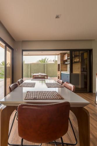 a dining room with a large table and chairs at LUXURIOUS NEW HOUSE, UNFORGETABLE EXPERIENCE. in Canoa Quebrada