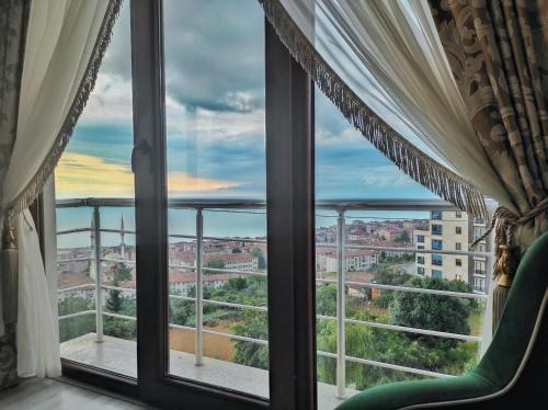 a window with a view of a city at Bahardali Suites - شقق غصن الربيع in Trabzon