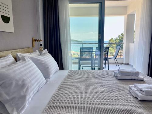 a bedroom with a bed with a view of the ocean at Elanthi in Skala Potamias
