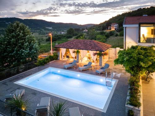 a swimming pool in a backyard with a gazebo at Krolo Villa&Wine in Trilj