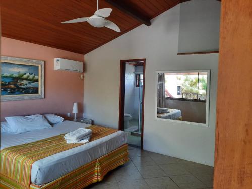 una camera con letto e ventilatore a soffitto di Casa Beto Búzios a Búzios