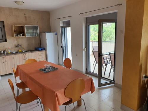 a kitchen and dining room with a table and chairs at Gemma di Cattaro Apartments in Kotor