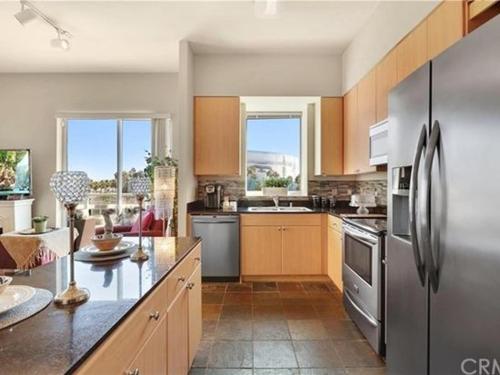 a kitchen with a stainless steel refrigerator at 2 Bed Ocean View Balconys Corner Unit LB Convention Center in Long Beach