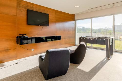 a living room with a flat screen tv on a wall at New & Modern APT - 100 MBPS 15 min from airport in San José