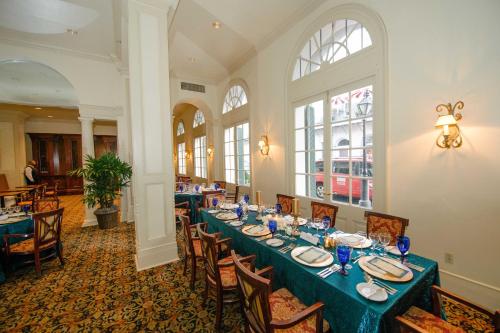 a dining room with a long table and chairs at Bourbon Orleans Hotel in New Orleans