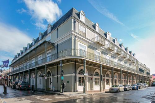 a building on a street with cars parked in front of it at Bourbon Orleans Hotel in New Orleans