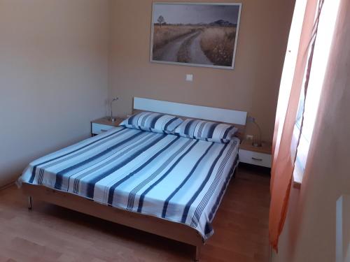 una camera con letto e lenzuola bianche e blu di Apartment EVA a Vodnjan (Dignano)