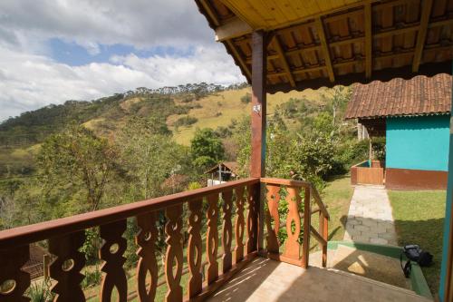 a balcony of a house with a view of a mountain at Chalés Cerejeira in Visconde De Maua