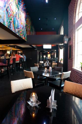a restaurant with tables and chairs and a colorful wall at Bourbon Orleans Hotel in New Orleans