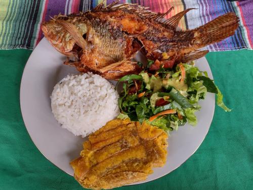 a plate of food with seafood and rice on a table at Villa Falian Nido el Gorrión in Viotá