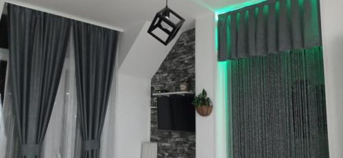 a bathroom with black and green curtains and a mirror at Apartment HOLIDAY LAKE - PIVA 2022 in Pluzine