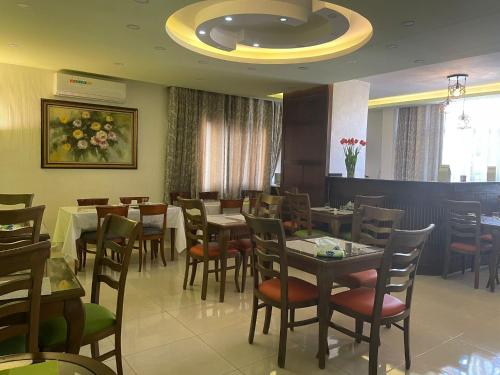 a dining room with tables and chairs in a restaurant at Tell Madaba in Madaba