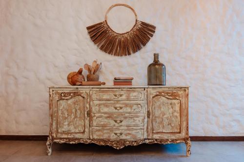 an old wooden dresser with a mirror on top of it at La Casa de Nelly - Medellín in Medellín