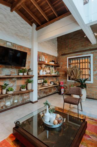 a living room with a glass table and a chair at La Casa de Nelly - Medellín in Medellín